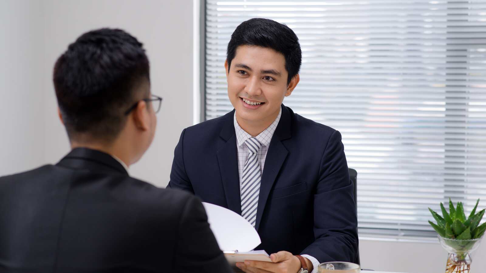 Job Interview Two Business Professionals Greeting New Colleague Min